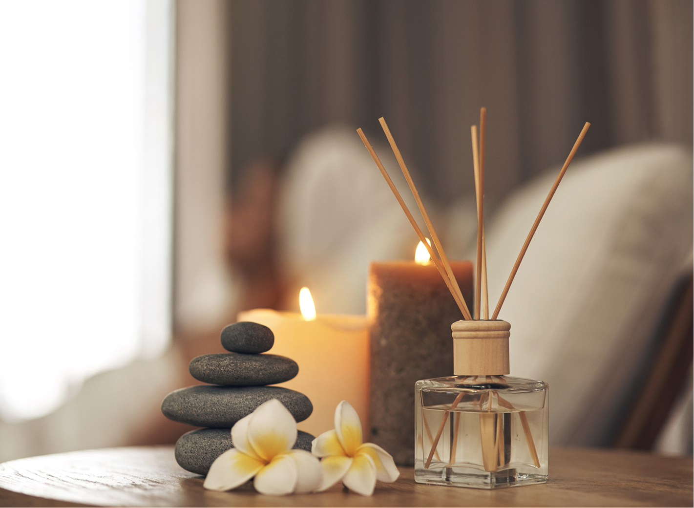 Spa scene with candles and diffuser