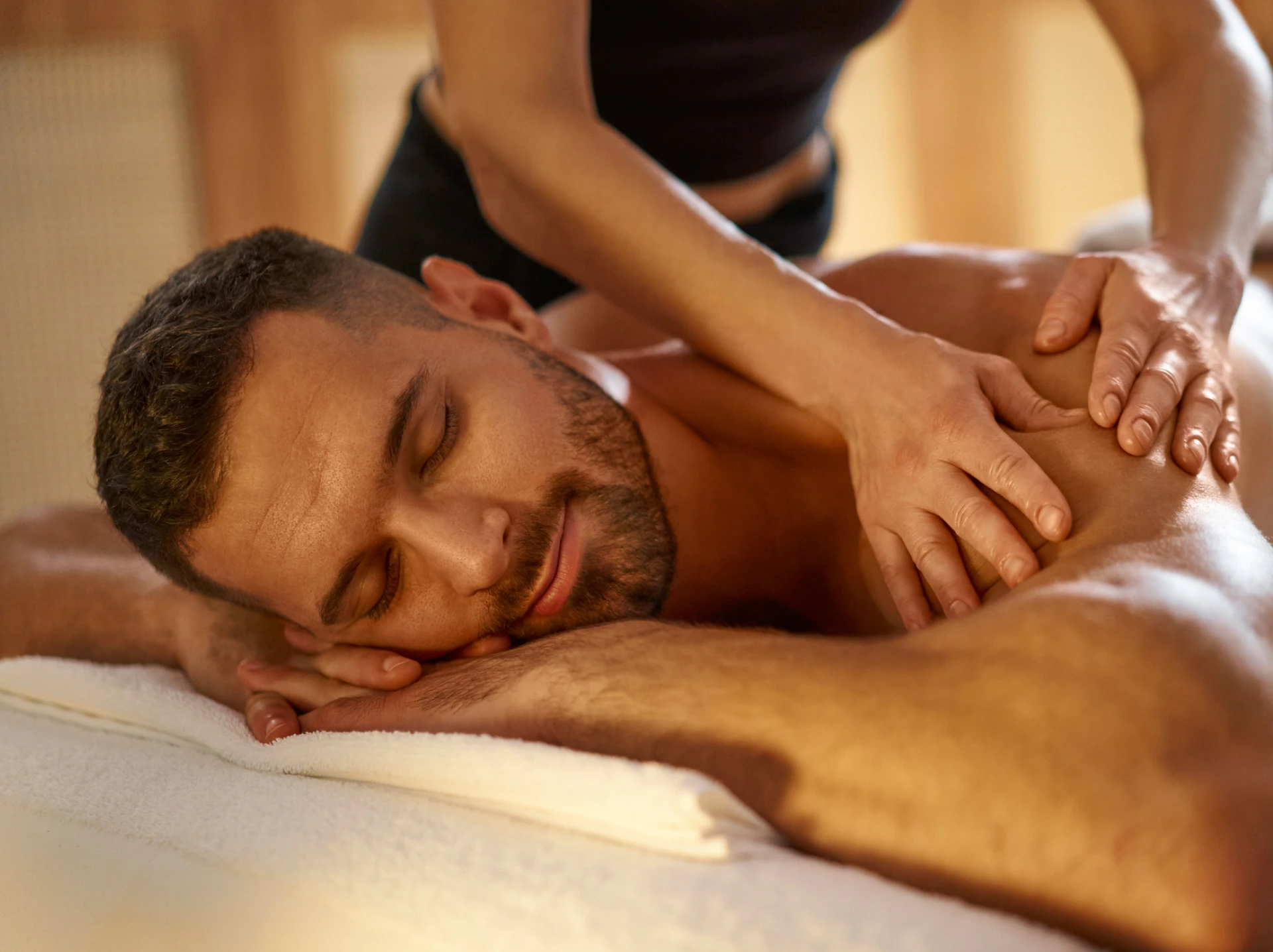 Person receiving shoulder massage therapy