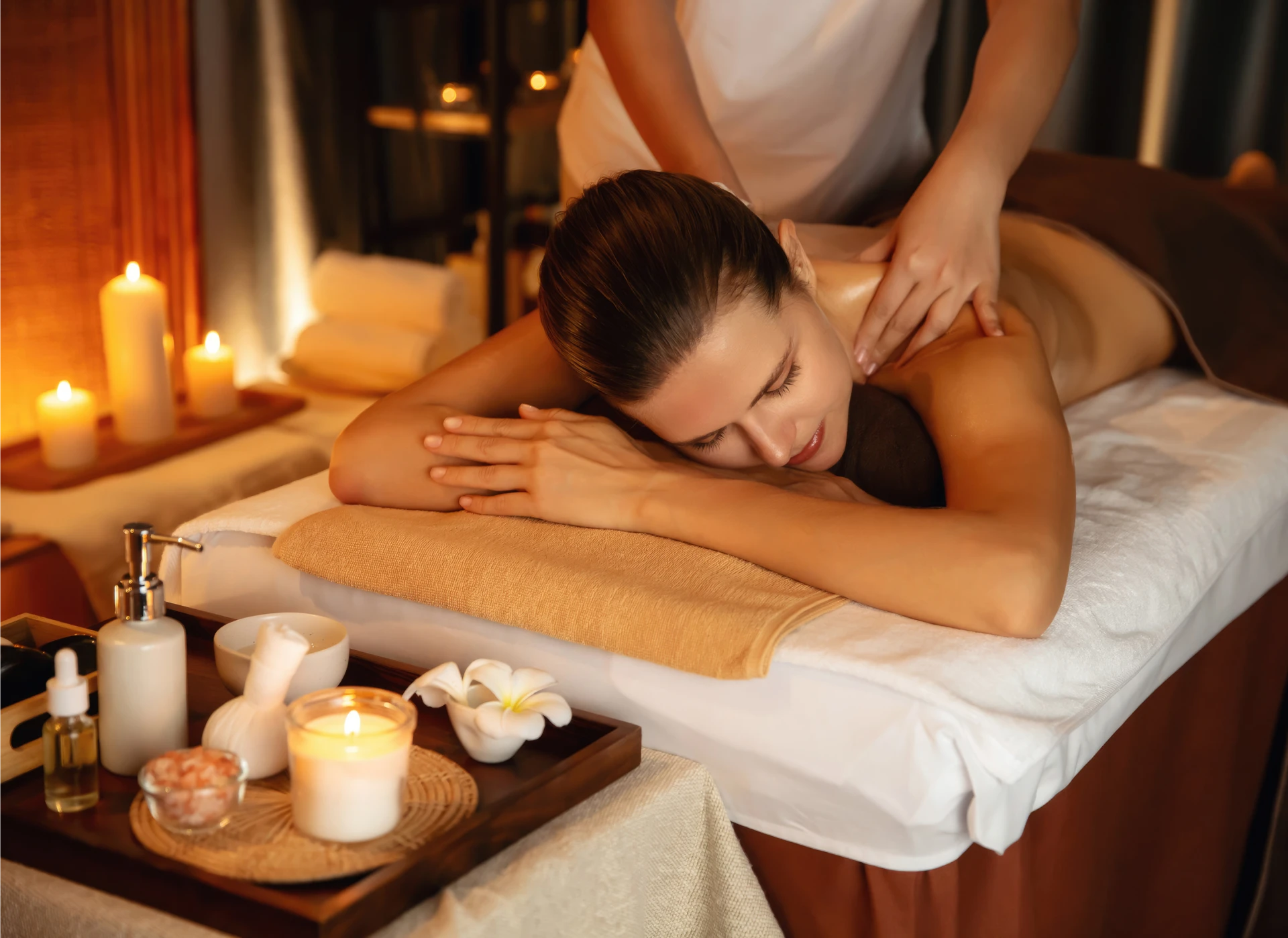 Woman receiving massage in spa setting